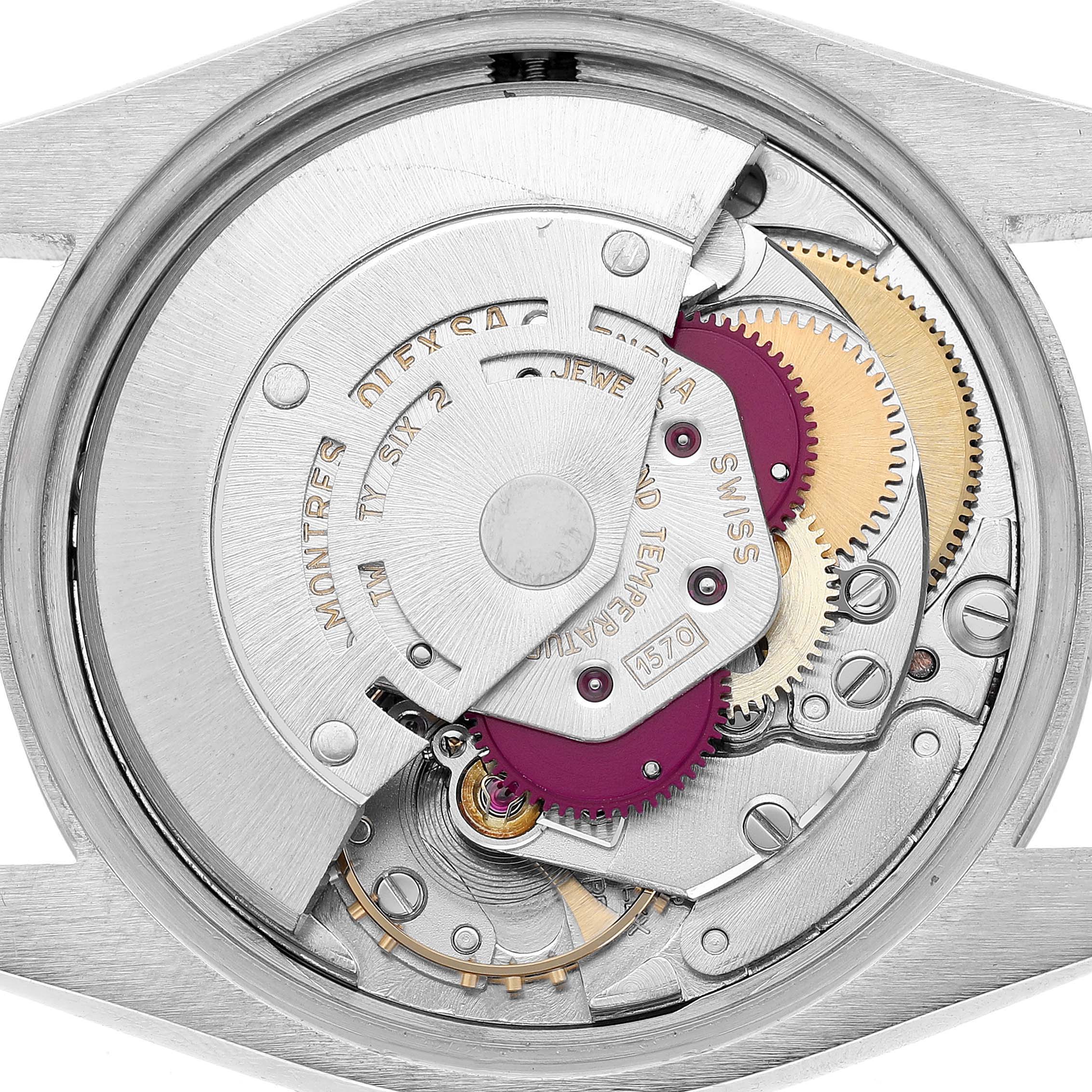 The image shows the movement of a Rolex Date 1500 Men's Stainless Steel Silver Dial watch from the back, highlighting the gears and components inside the case.
