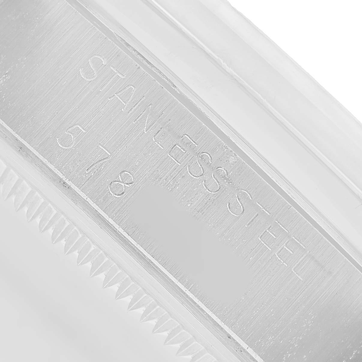 The image shows a close-up of the side of a Rolex Date 1500 Men's Stainless Steel Silver Dial watch, focusing on the engraved stainless steel case.