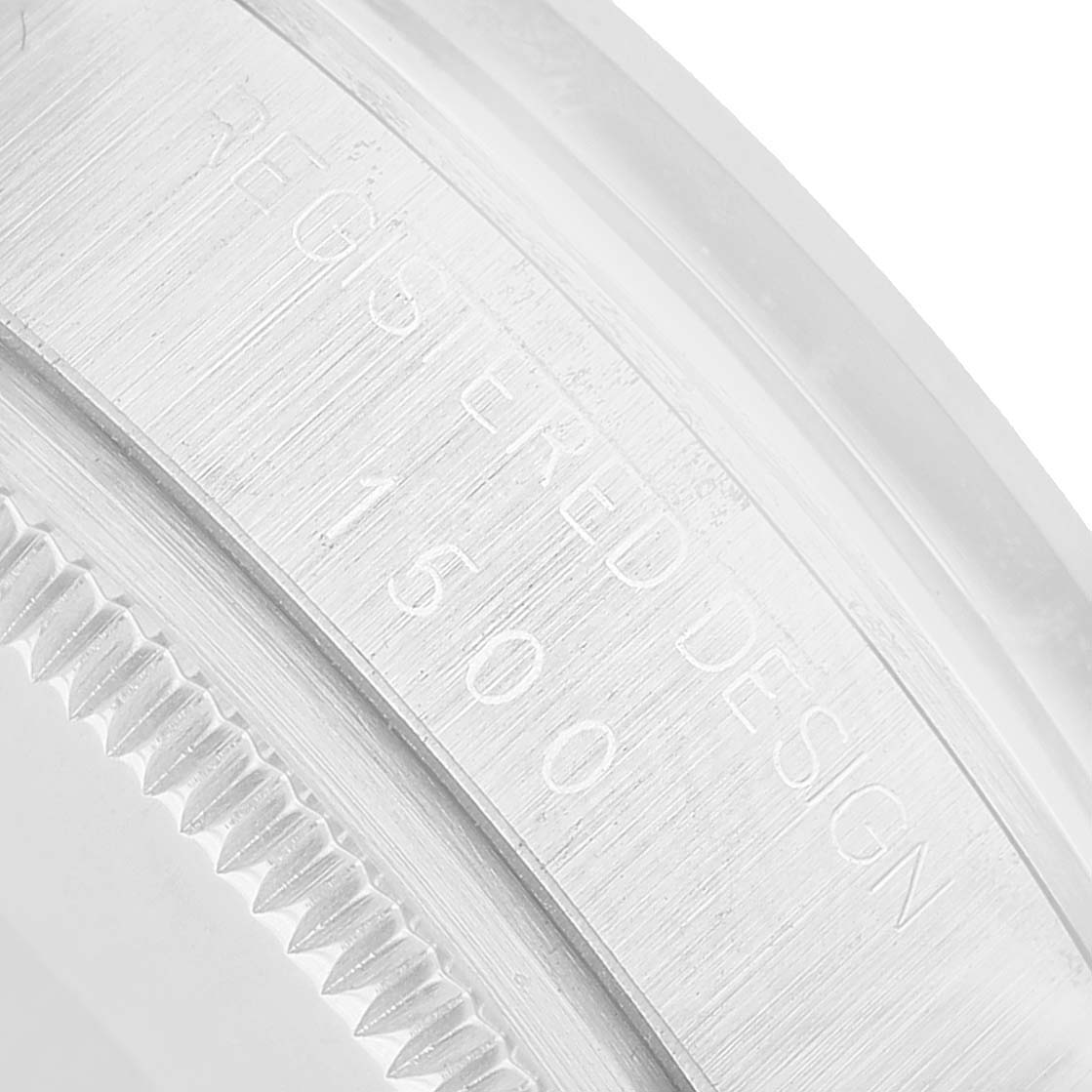 The image shows a close-up of the side of a Rolex Date 1500 Men's Stainless Steel Silver Dial model, highlighting the engraved serial number and part of the bezel.