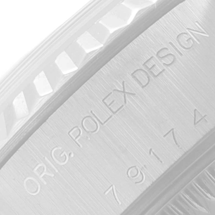 The image shows a close-up of the engraving on the side of a Rolex Datejust 79174 Women
s Stainless Steel Silver Dial 79174 Women
s Stainless Steel Silver Dial watch case.