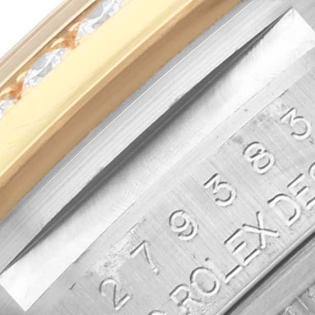 The image shows a close-up of the bezel and engraved side of a Rolex Datejust 279383 Women's Steel and Gold (two tone) Purple Dial 279383 Women's Steel and Gold (two tone) Purple Dial watch, featuring gold and diamond detailing.