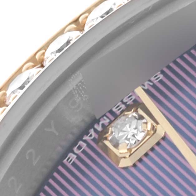 The image shows a close-up of a Rolex Datejust 279383 Women's Steel and Gold (two tone) Purple Dial 279383 Women's Steel and Gold (two tone) Purple Dial watch's bezel and part of its dial with a diamond marker.