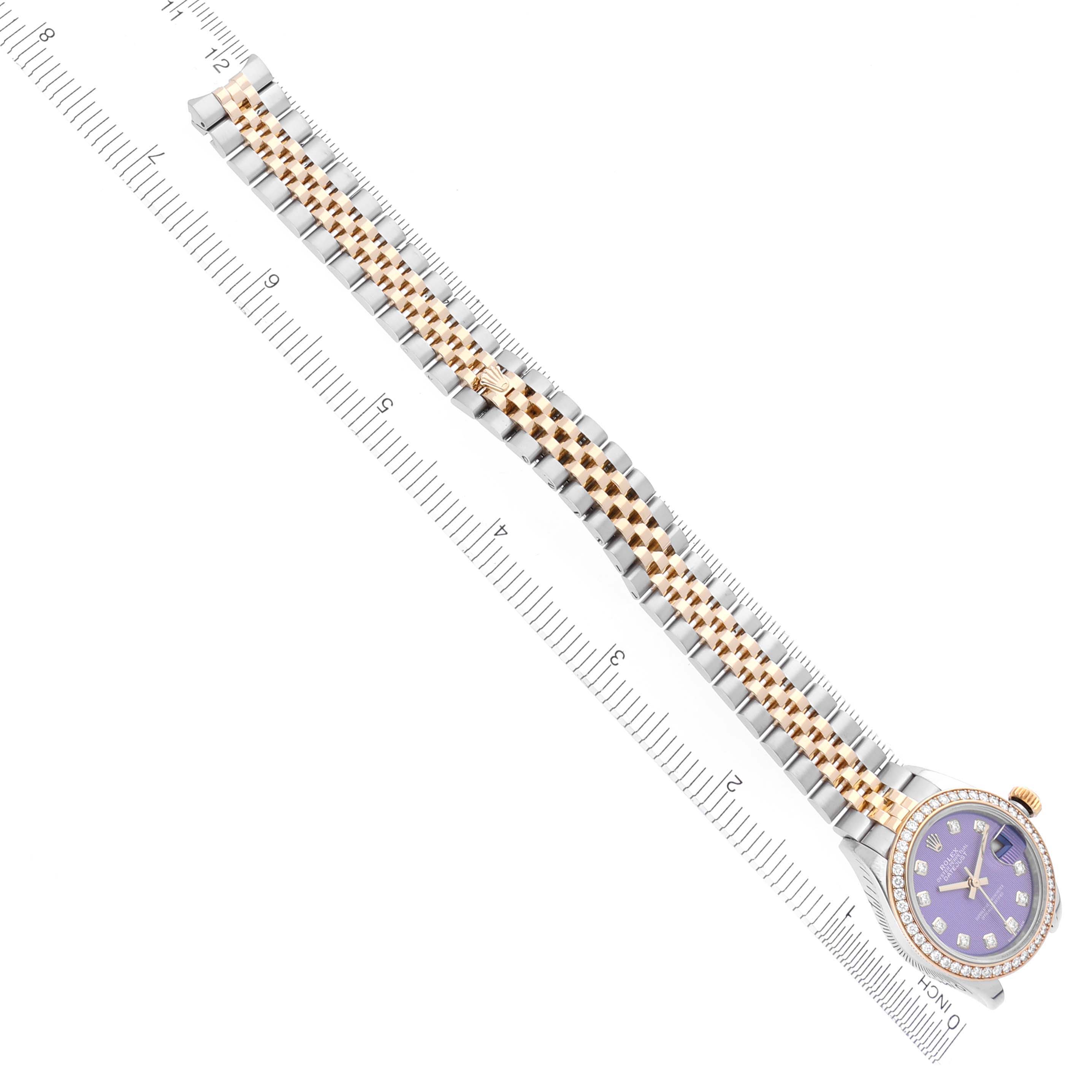 The Rolex Datejust 279383 Women's Steel and Gold (two tone) Purple Dial 279383 Women's Steel and Gold (two tone) Purple Dial watch is shown from a top-down angle, highlighting the bracelet, face, and bezel alongside a ruler for scale.
