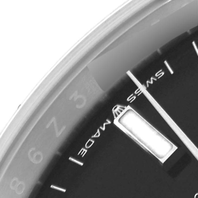 The image shows a close-up of the dial of a Rolex Datejust 126200 Men's Stainless Steel Black Dial 126200 Men's Stainless Steel Black Dial watch, highlighting the hour markers and partial bezel.