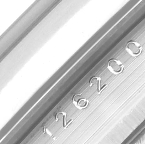 The image shows a close-up of the engraving on the inner bezel of a Rolex Datejust 126200 Men's Stainless Steel Black Dial 126200 Men's Stainless Steel Black Dial watch.