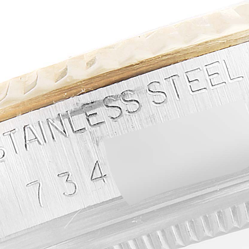 This close-up image shows the side engraving of a Rolex Vintage Collection 16013 Men's Steel and Gold (two tone) Silver Dial 16013 Men's Steel and Gold (two tone) Silver Dial watch, highlighting "STAINLESS STEEL" and a partial serial number.