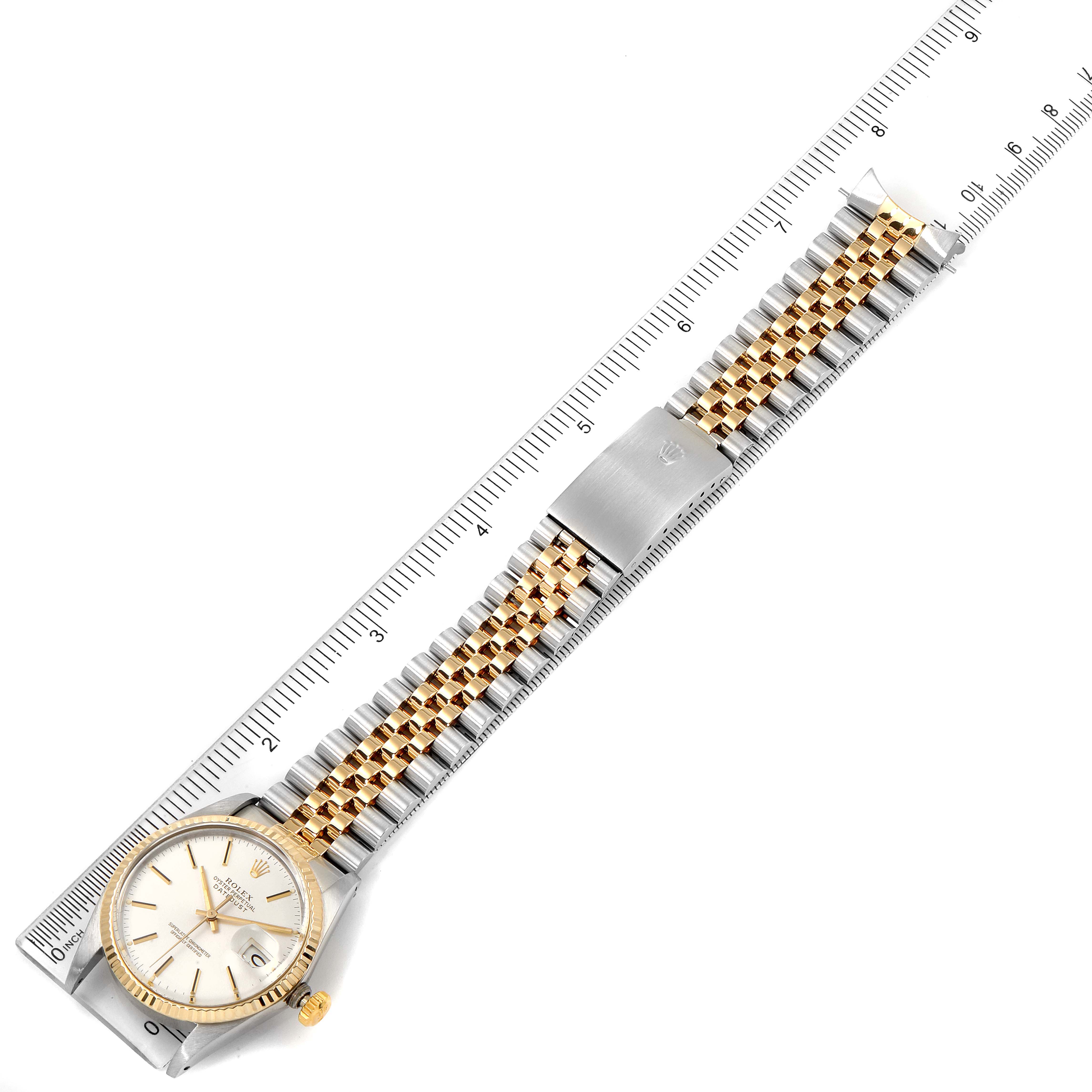 The image shows a Vintage Collection Rolex watch laid flat with its band extended and a ruler underneath for size reference.