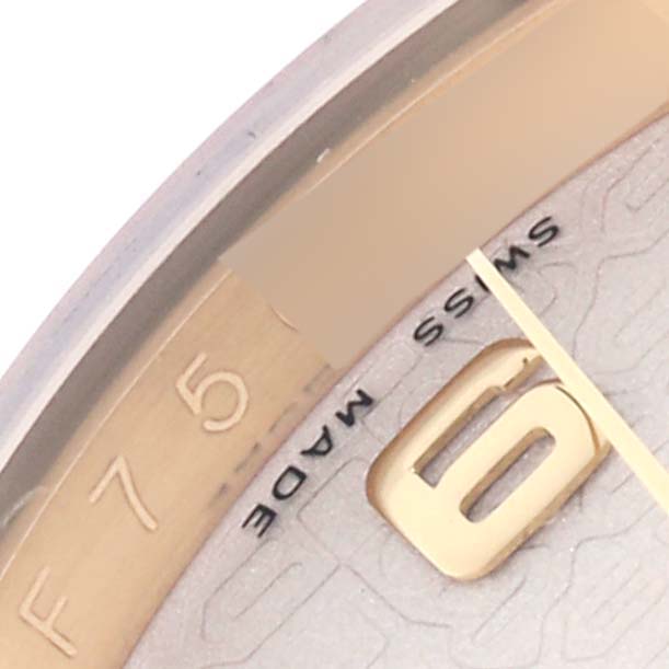 The image shows a close-up of the dial of a Rolex Datejust 116138 Men's Yellow Gold White Dial 116138 Men's Yellow Gold White Dial watch, focusing on the 6 o'clock marker and part of the text.