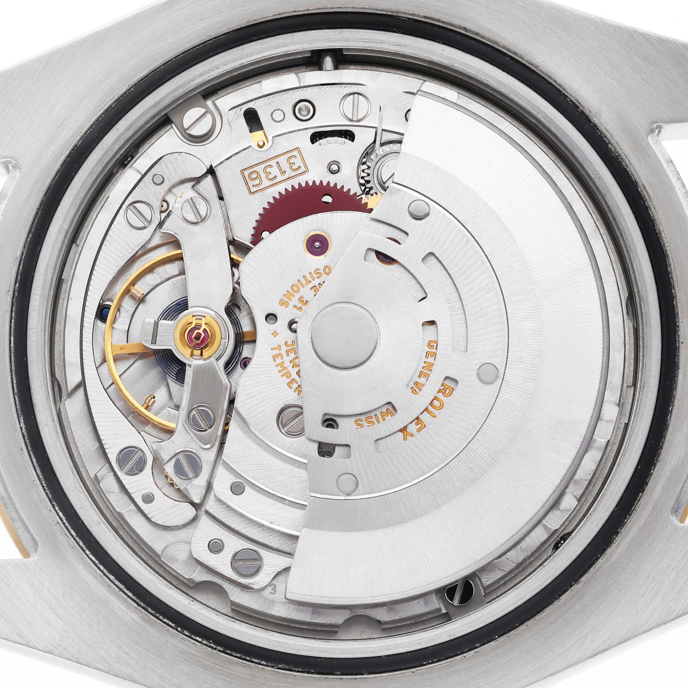 The image shows a detailed view of the movement inside a Rolex Datejust 41 116333 Men's Steel and Gold (two tone) Grey Dial, highlighting gears and the automatic rotor.