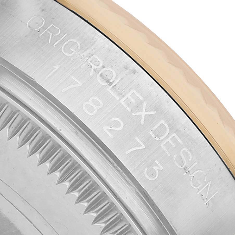 The image shows a close-up of the Rolex Datejust 178273 Women's Steel and Gold (two tone) Black Dial's case side engraving, highlighting the model number and design details.