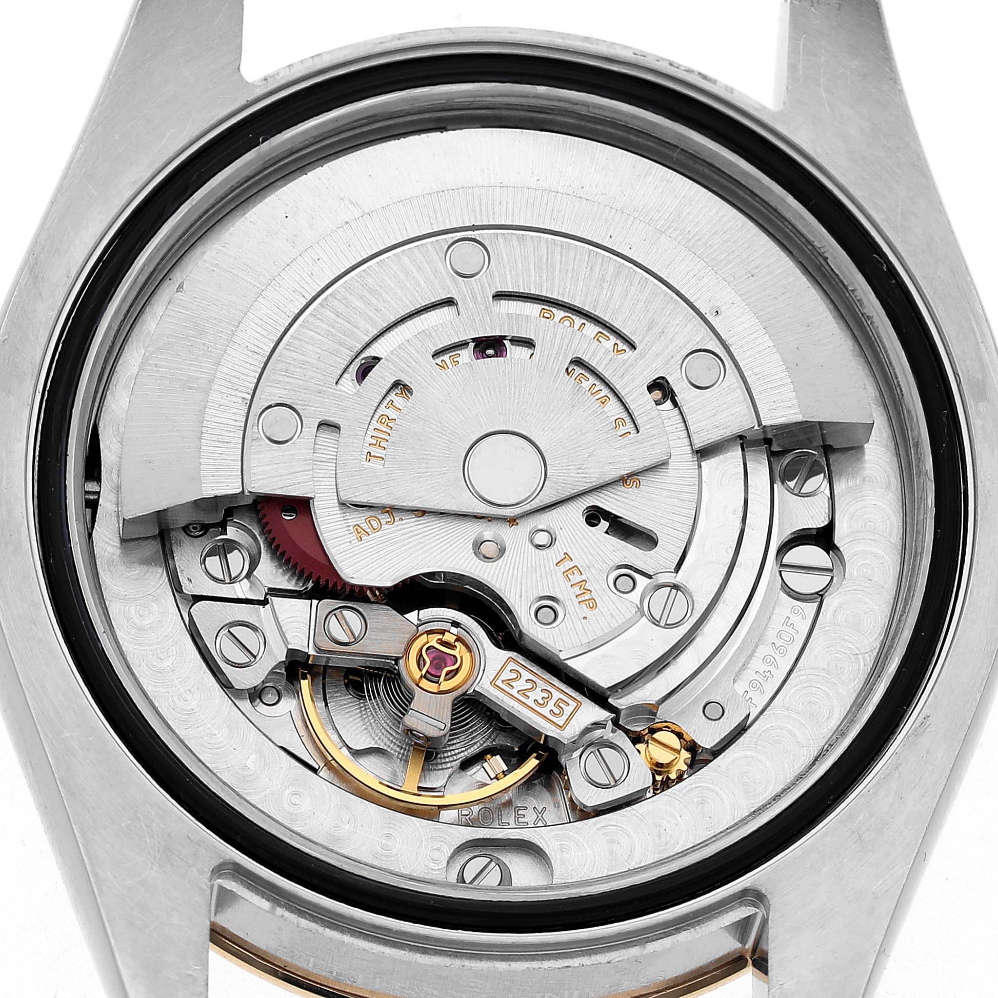 The image shows the movement of a Rolex Datejust 178273 Women's Steel and Gold (two tone) Black Dial watch from the back, highlighting its intricate components.