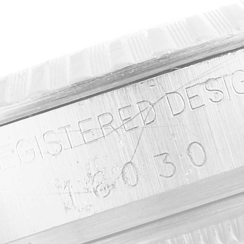 This image shows a close-up angle of the engraved casing on a Rolex Vintage Collection 16030 Men's Stainless Steel Silver Dial 16030 Men's Stainless Steel Silver Dial watch.