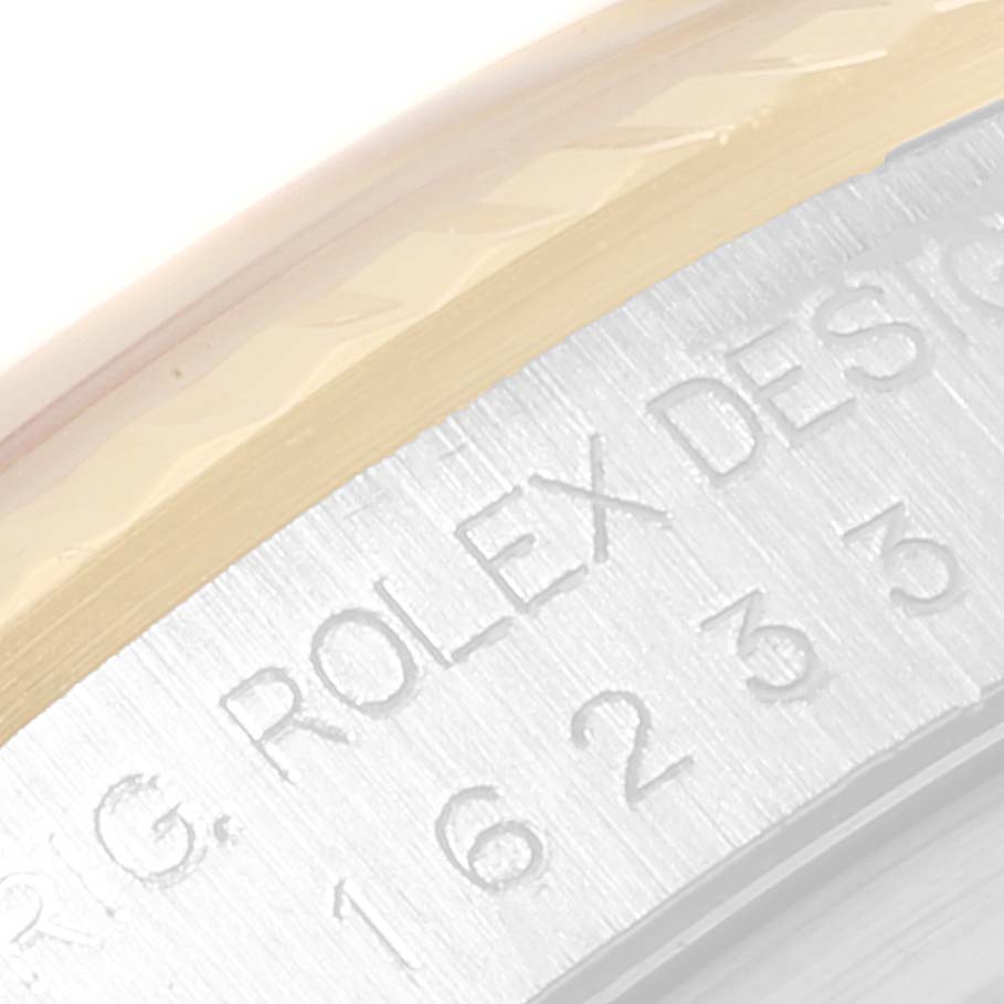 This is a close-up of the side of the Rolex Datejust 16233 Men's Steel and Gold (two tone) Black Dial 16233 Men's Steel and Gold (two tone) Black Dial watch, showing the engraved branding and part of the bezel.