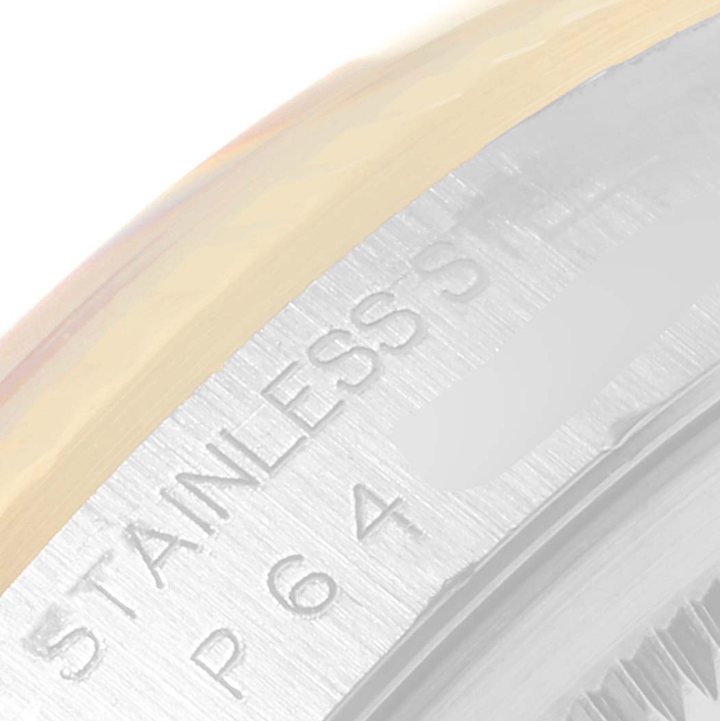 This image shows a close-up of the engraved "STAINLESS STEEL" marking on the bezel of a Rolex Datejust 16233 Men's Steel and Gold (two tone) Black Dial 16233 Men's Steel and Gold (two tone) Black Dial watch.