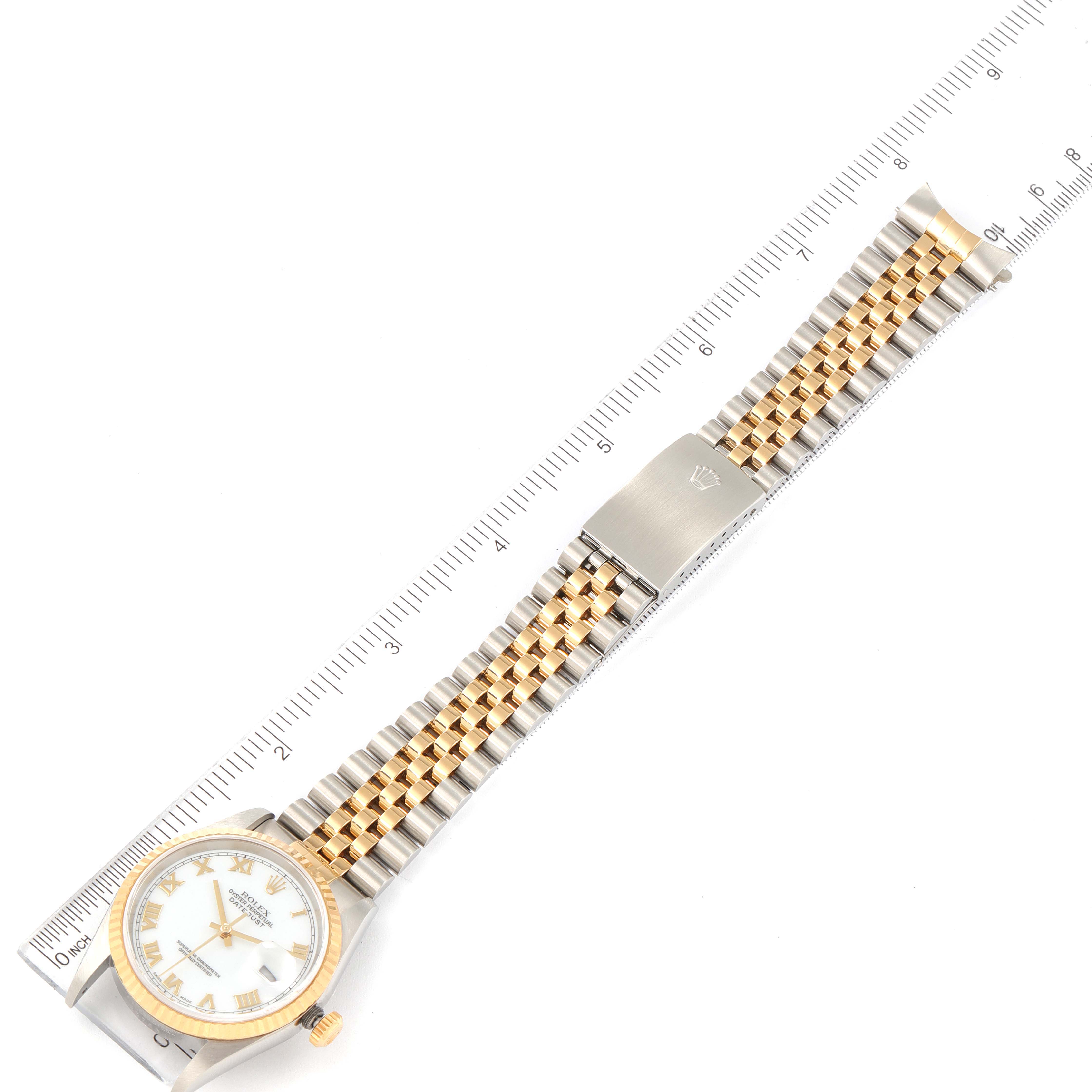 This image shows a Rolex Datejust 16233 Men's Steel and Gold (two tone) White Dial 16233 Men's Steel and Gold (two tone) White Dial watch laid flat with a ruler for scale, displaying the face, bezel, crown, and bracelet.