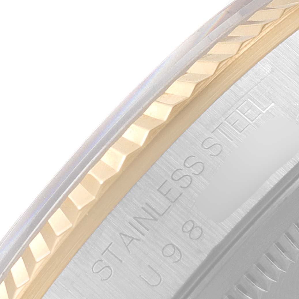 This image shows a close-up of the bezel and part of the case back of a Rolex Datejust 16233 Men's Steel and Gold (two tone) Blue Dial 16233 Men's Steel and Gold (two tone) Blue Dial watch, highlighting the stainless steel engraving.