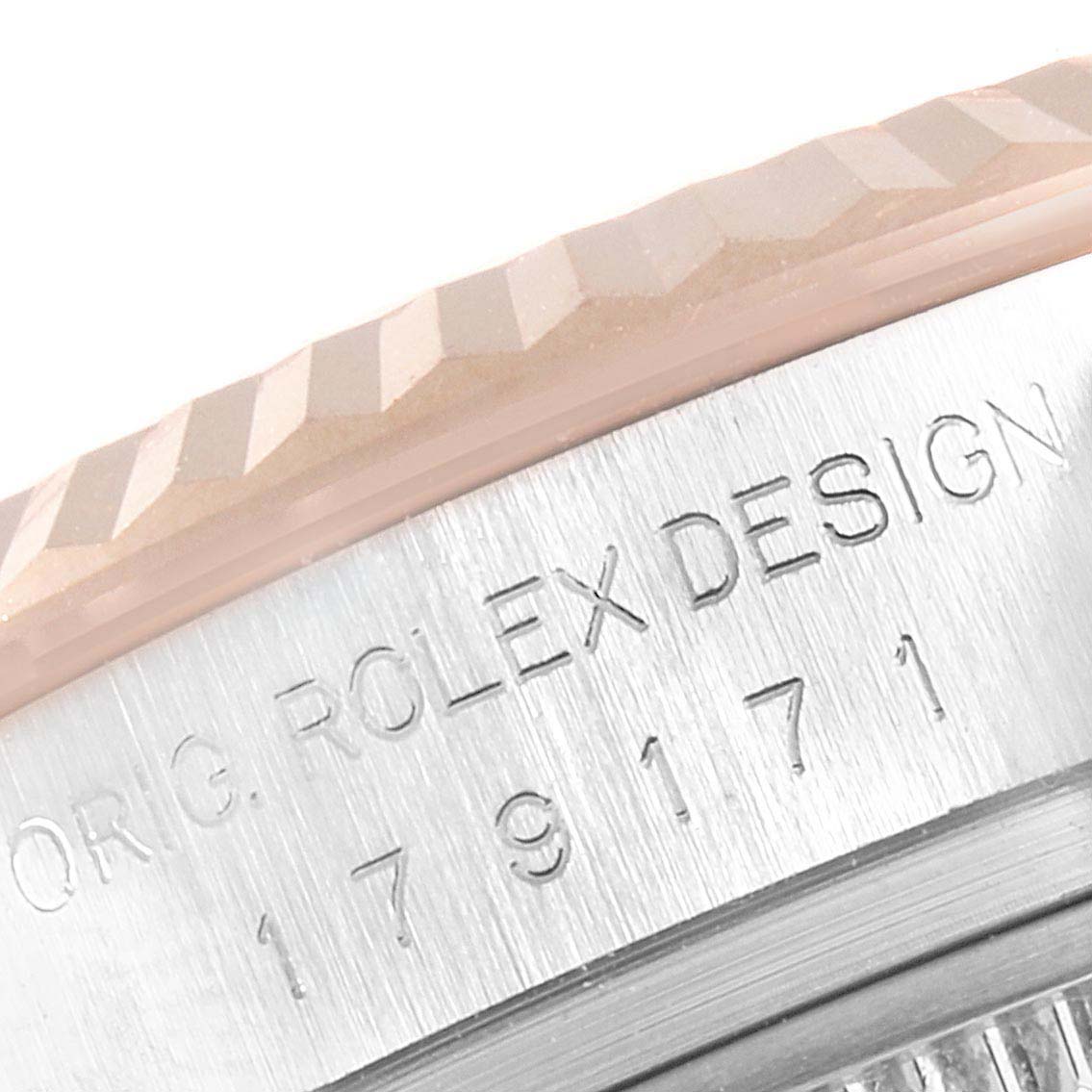 This close-up angle shows the engraved text and fluted bezel of a Rolex Datejust 179171 Women's Rose Gold Silver Dial 179171 Women's Rose Gold Silver Dial watch.