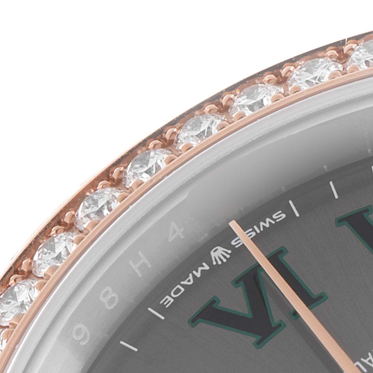 This close-up image of the Rolex Datejust 126281 Men's Steel and Gold (two tone) Grey Dial 126281 Men's Steel and Gold (two tone) Grey Dial model features the watch bezel adorned with diamonds, the dial, and the minute hand.