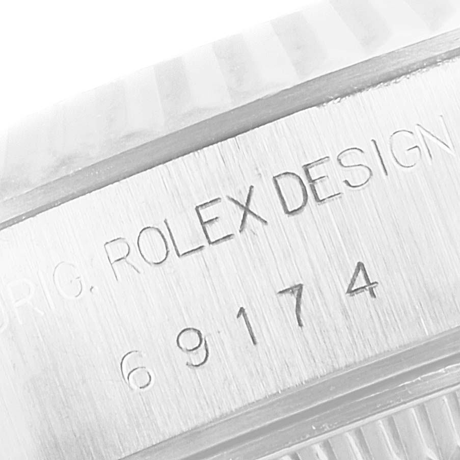 This image shows the side engraving with the serial number of a Rolex Datejust 69174 Women's Stainless Steel Silver Dial 69174 Women's Stainless Steel Silver Dial watch.