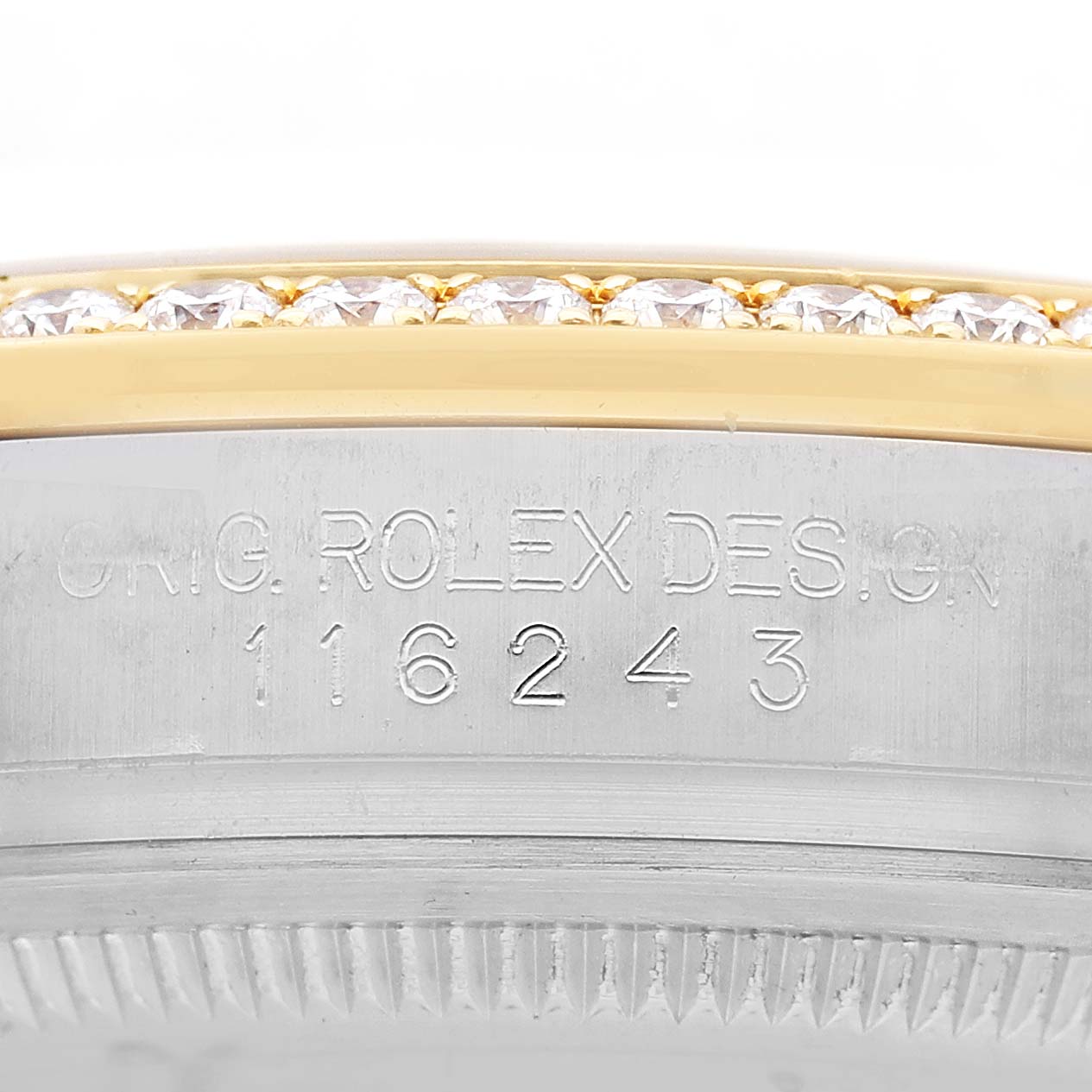 The image shows the side view of a Rolex Datejust 116243 Men's Steel and Gold (two tone) Champagne Dial, highlighting the engraved model number and part of the diamond-set bezel.