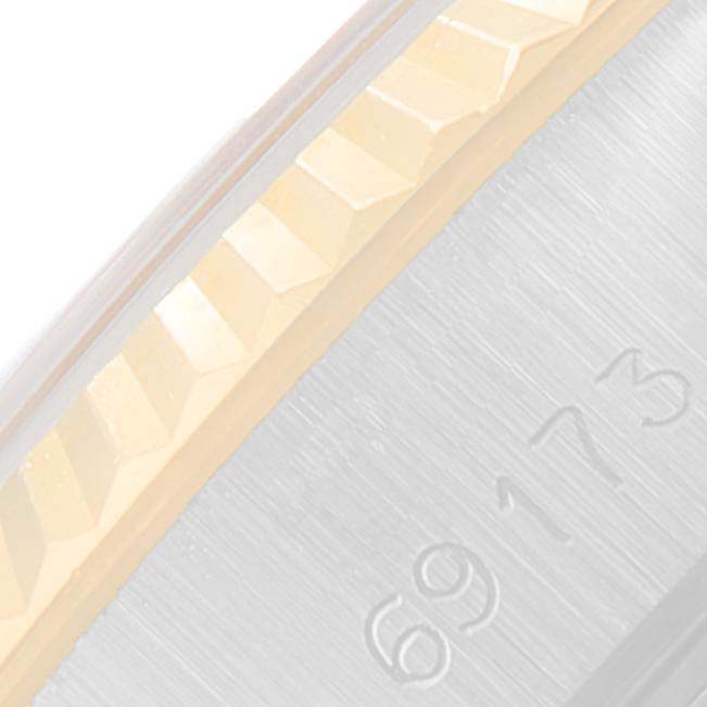 This close-up image shows the fluted bezel and part of the stainless steel case of a Rolex Datejust 69173 Women
s Steel and Gold (two tone) Champagne Dial 69173 Women
s Steel and Gold (two tone) Champagne Dial watch.