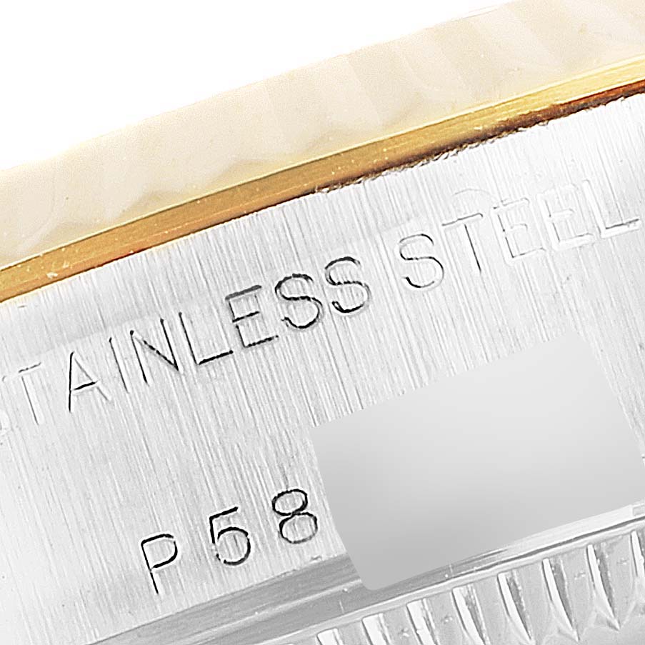 This close-up image shows part of the stainless steel case of a Rolex Datejust 79173 Women's Steel and Gold (two tone) Silver Dial 79173 Women's Steel and Gold (two tone) Silver Dial watch.