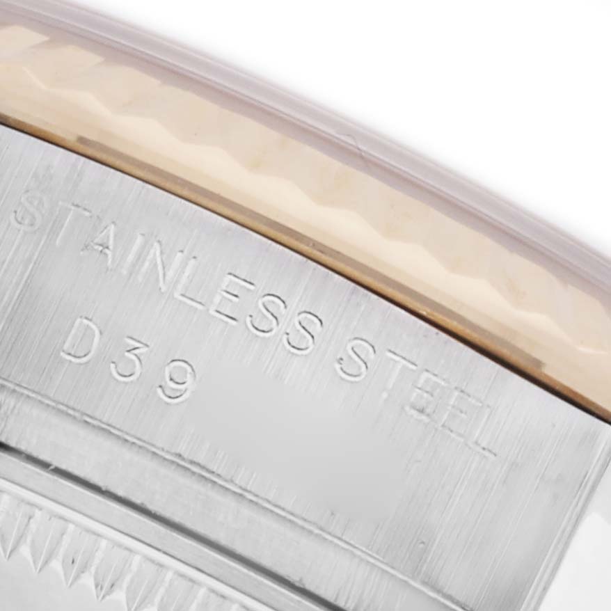 The image shows the engraved side of the stainless steel bezel of a Rolex Datejust 179173 Women's Steel and Gold (two tone) White Dial 179173 Women's Steel and Gold (two tone) White Dial watch, focused on the text details.