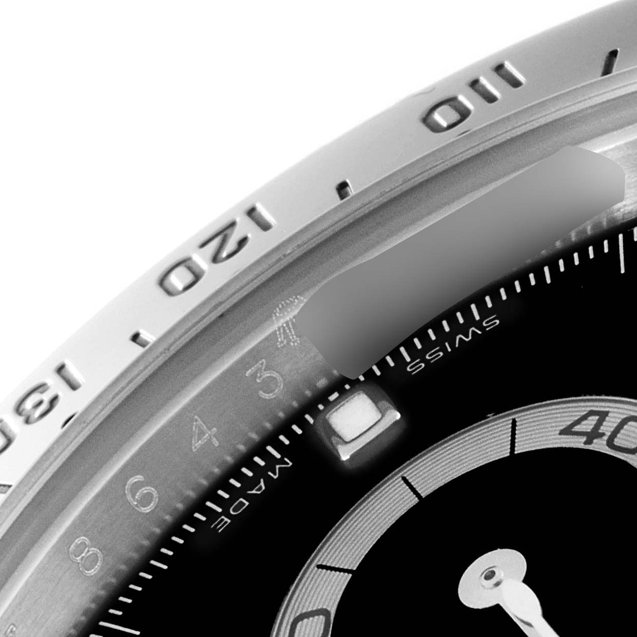 This close-up angle shows the bezel, part of the dial, and a portion of the sub-dial of the Rolex Daytona 116520 Men's Stainless Steel Black Dial 116520 Men's Stainless Steel Black Dial watch.