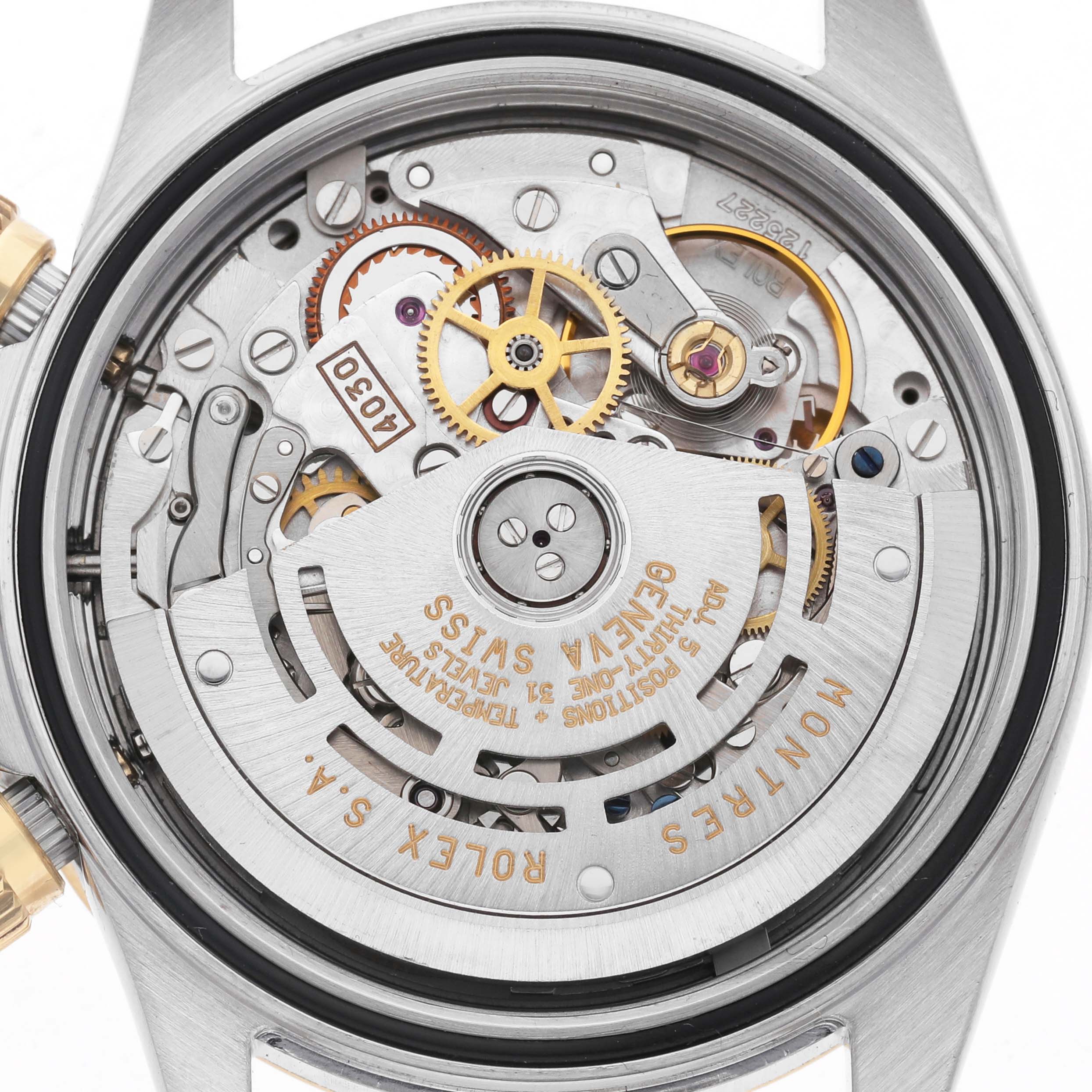 The image shows the back view of a Rolex Daytona 16523 Men's Steel and Gold (two tone) Champagne Dial watch, highlighting its intricate movement and internal mechanics.