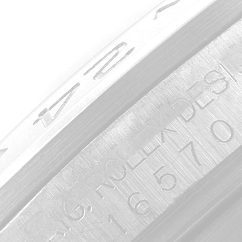 This close-up image shows the engraved details on the side of the bezel and case of a Rolex Explorer 16570 Men's Stainless Steel Black Dial 16570 Men's Stainless Steel Black Dial watch.