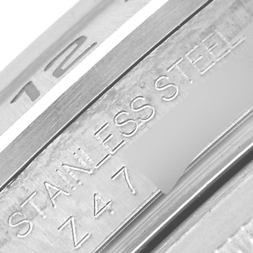 The image shows a close-up of the inner engraving on a Rolex Explorer 16570T Men's Stainless Steel Black Dial 16570T Men's Stainless Steel Black Dial, highlighting the "STAINLESS STEEL" text.
