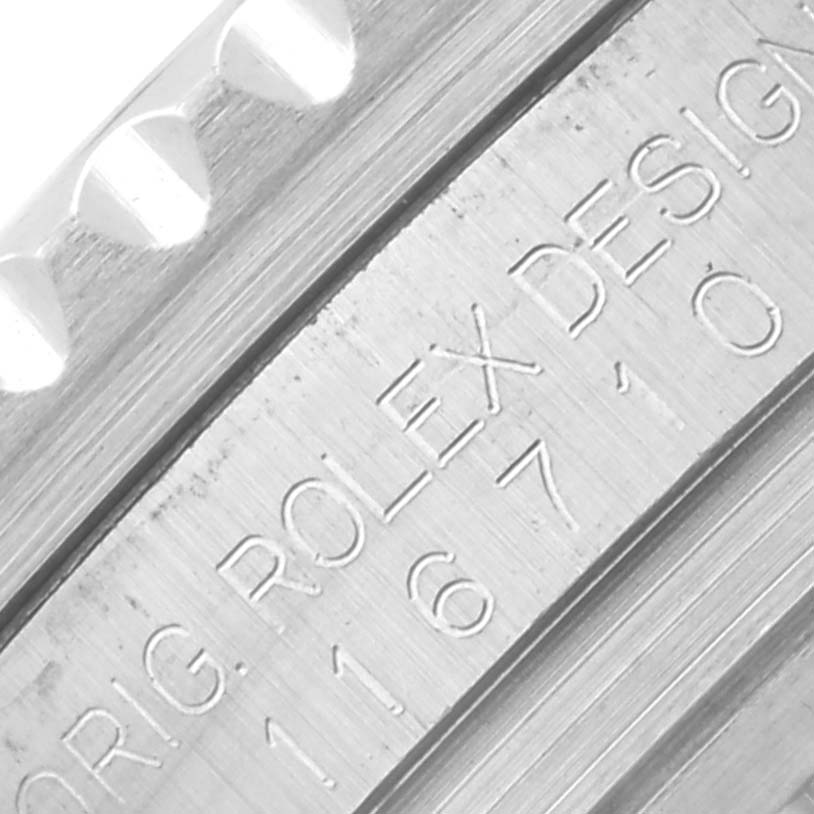 The image shows a close-up of the engraved side of the Rolex GMT-Master 116710LN Men's Stainless Steel Black Dial 116710LN Men's Stainless Steel Black Dial, highlighting model details and bezel edge.