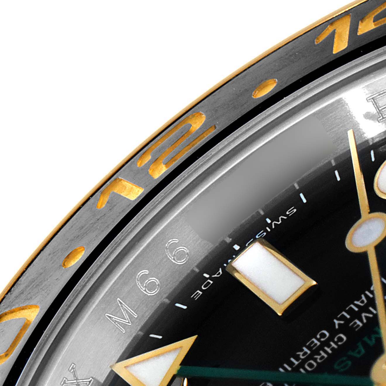 This image shows a close-up angle of the dial and bezel of the Rolex GMT-Master 116713 Men's Steel and Gold (two tone) Black Dial 116713 Men's Steel and Gold (two tone) Black Dial.