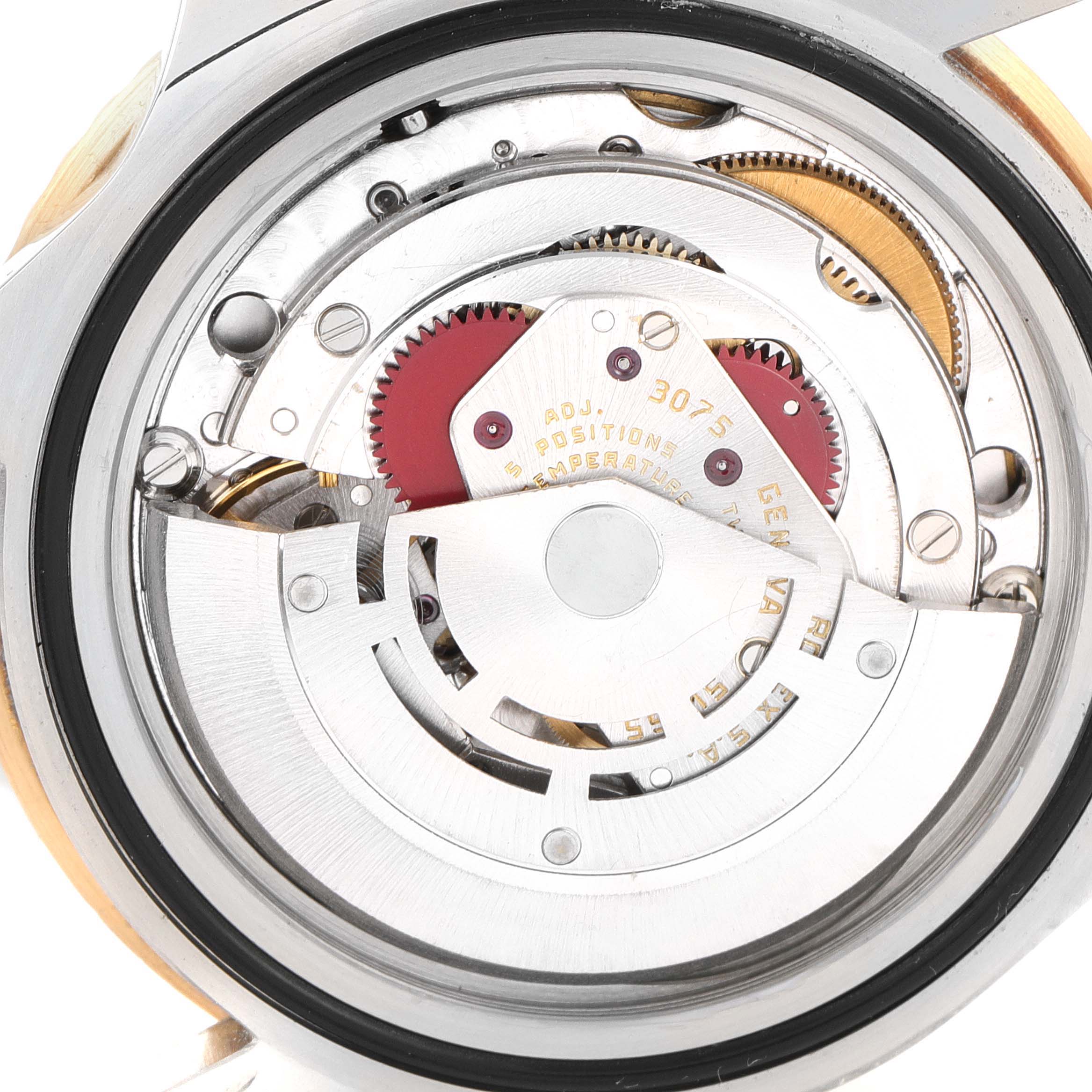 The image shows the internal mechanism of the Rolex GMT-Master 16753 Men's Steel and Gold (two tone) Black Dial 16753 Men's Steel and Gold (two tone) Black Dial watch from a back angle, revealing gears and moving parts.