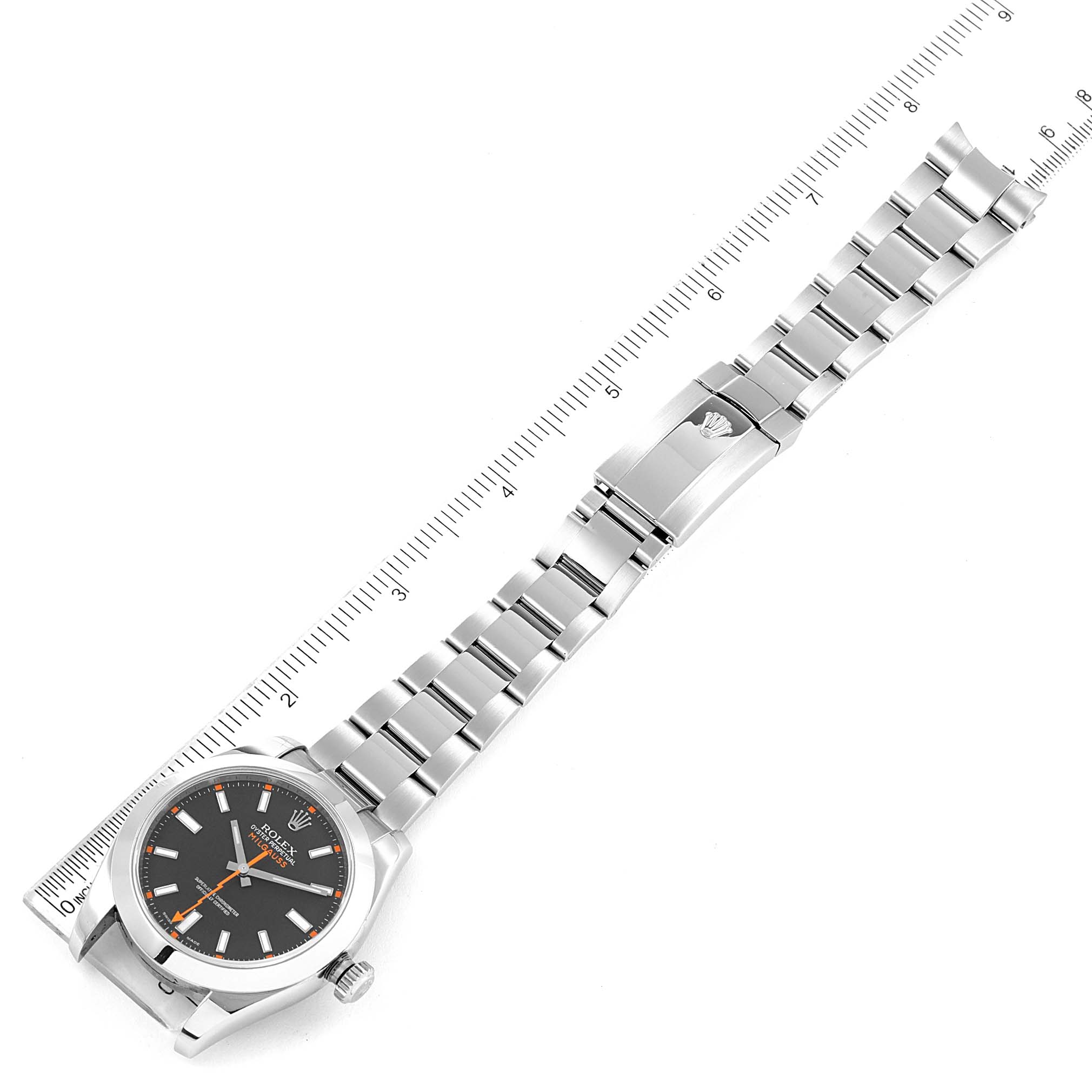 The image shows a Rolex Milgauss 116400 Men's Stainless Steel Black Dial 116400 Men's Stainless Steel Black Dial watch lying flat, with its face, bracelet, and clasp visible next to a ruler for scale.
