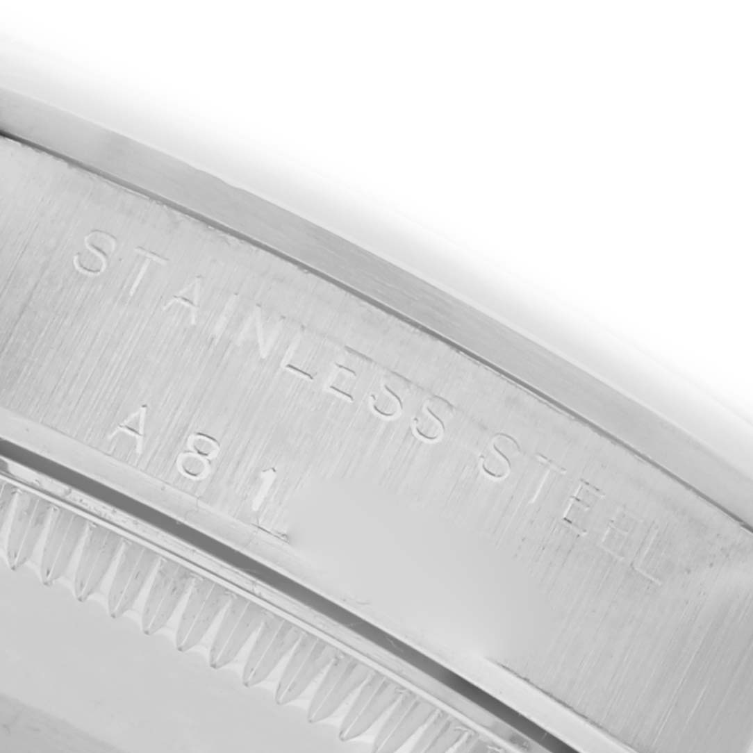 The image shows a close-up of the case back edge engraved with "STAINLESS STEEL" on a Rolex Mid-Size 77080 Women's Stainless Steel Black Dial 77080 Women's Stainless Steel Black Dial watch.