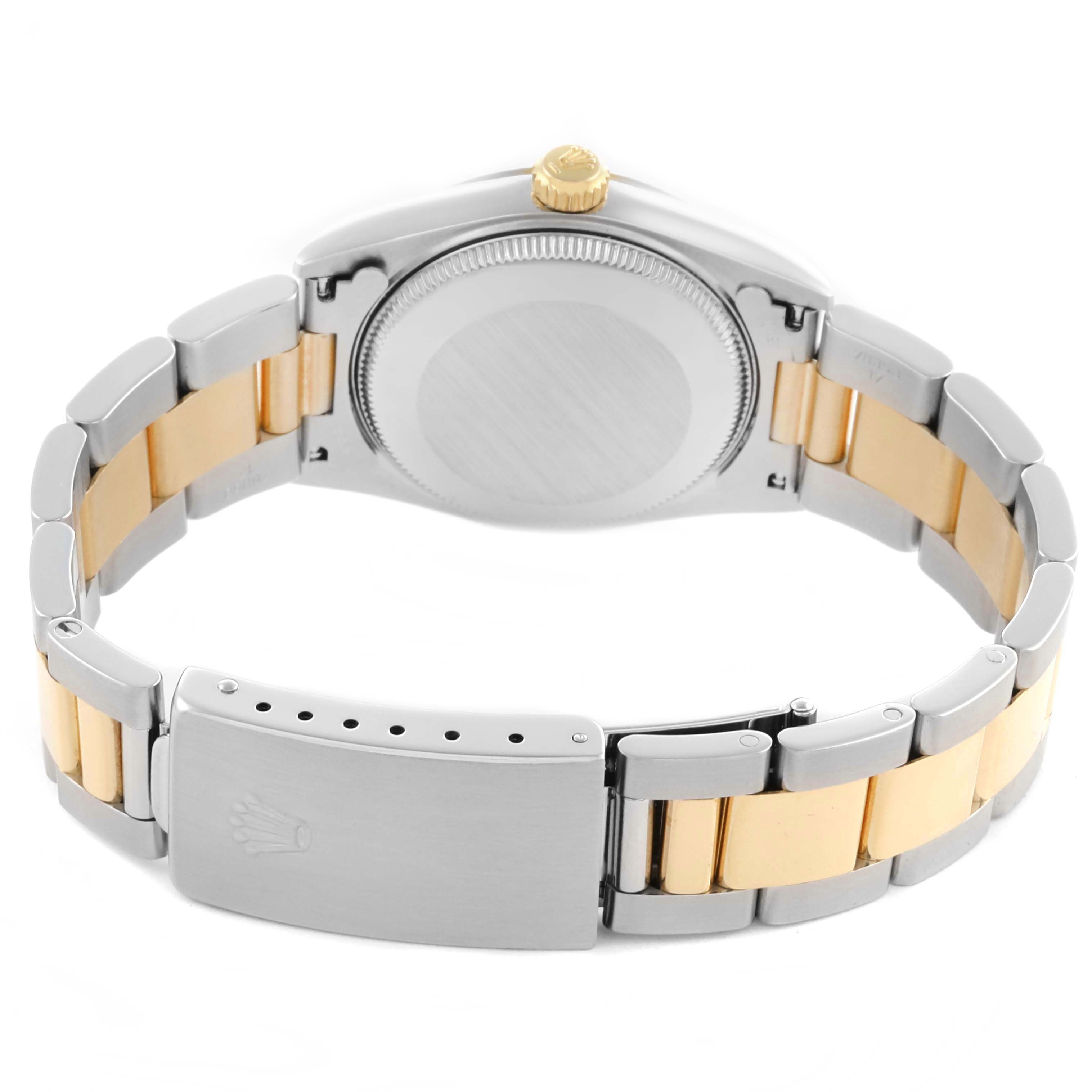 The angle shows the back of the Rolex Mid-Size 77513 Women's Steel and Gold (two tone) Champagne Dial 77513 Women's Steel and Gold (two tone) Champagne Dial watch, including the case back and two-tone bracelet with clasp.