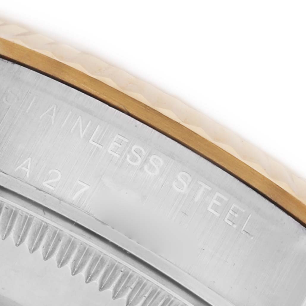 The Rolex Mid-Size 77513 Women's Steel and Gold (two tone) Champagne Dial 77513 Women's Steel and Gold (two tone) Champagne Dial watch is shown close-up, highlighting the stainless steel bezel with engraved text.