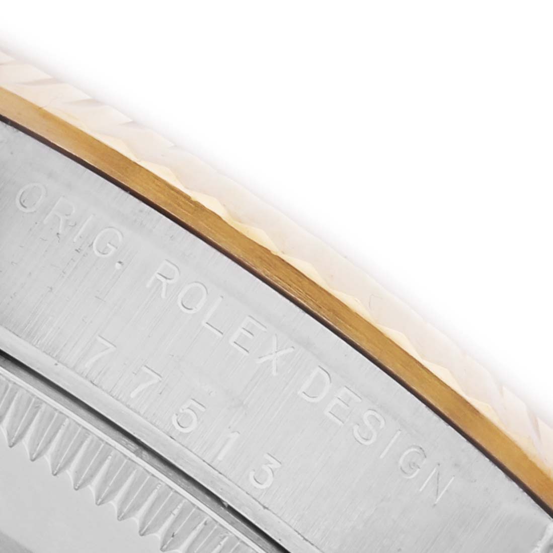 The image shows a close-up of the side of a Rolex Mid-Size 77513 Women's Steel and Gold (two tone) Champagne Dial 77513 Women's Steel and Gold (two tone) Champagne Dial watch, featuring the engraved design and a two-tone bezel.