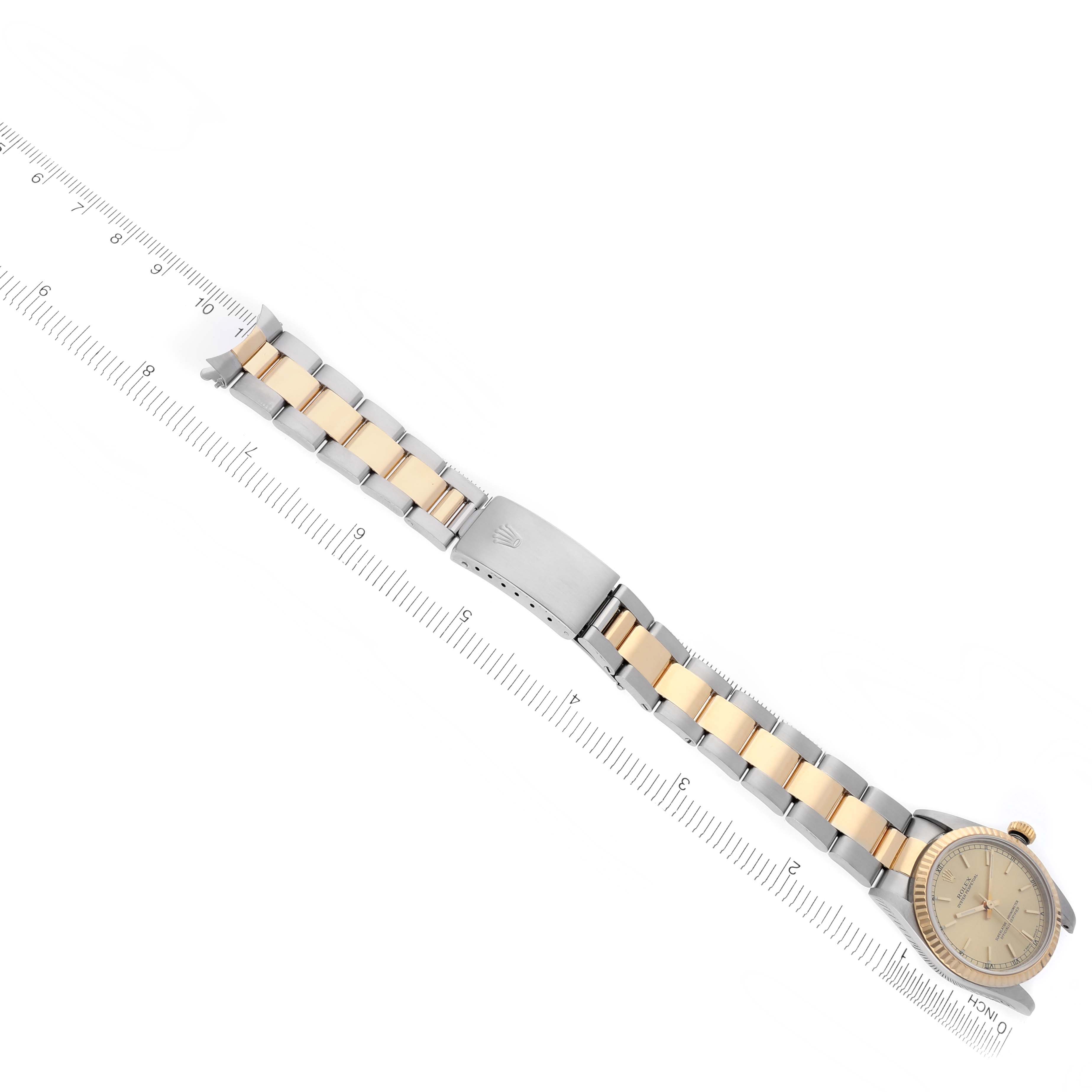 The image shows a Rolex Mid-Size 77513 Women's Steel and Gold (two tone) Champagne Dial 77513 Women's Steel and Gold (two tone) Champagne Dial watch laid flat, displaying the band, clasp, and face from a top view angle.