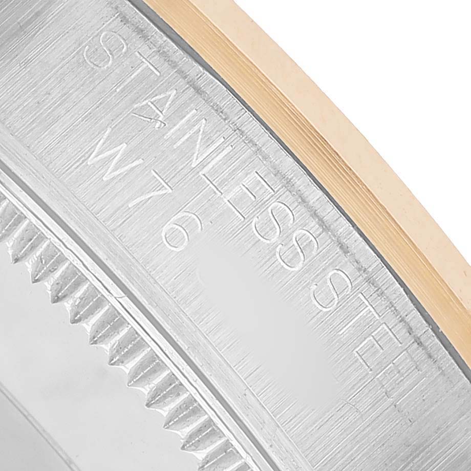 The image shows a close-up of the case back edge of a Rolex Oyster Perpetual 67483 Women's Steel and Gold (two tone) Black Dial, focusing on the stainless steel engraving.