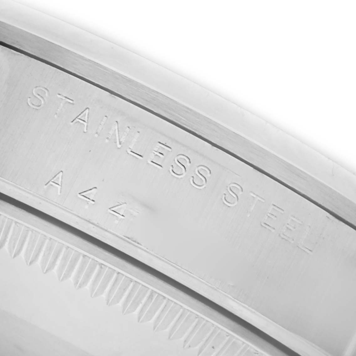 The image shows a close-up of the rim of a stainless steel Mid-Size Rolex watch, focusing on the engraved text.