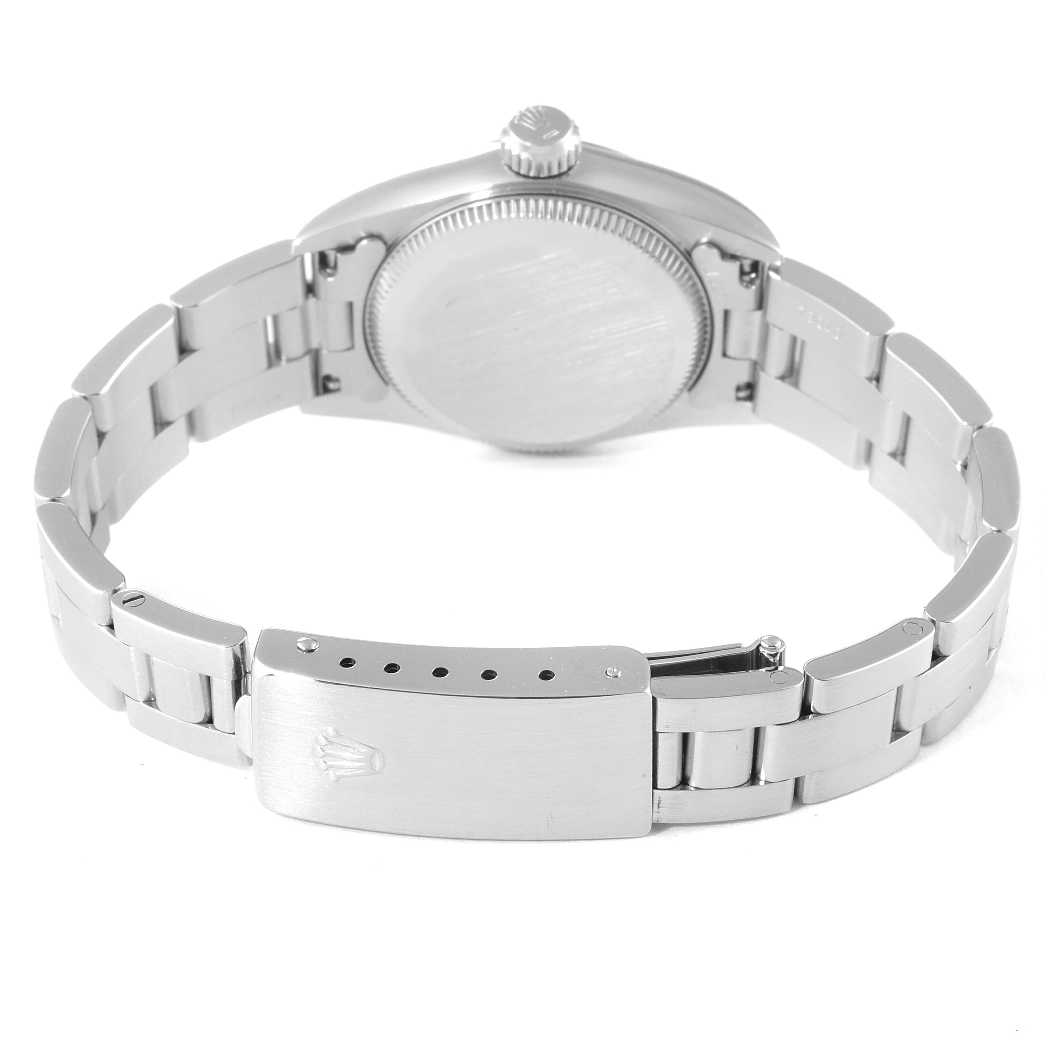 The image shows the back view of a Rolex Oyster Perpetual 67180 Women
s Stainless Steel White Dial 67180 Women
s Stainless Steel White Dial watch, focusing on the case back and the clasp of the bracelet.