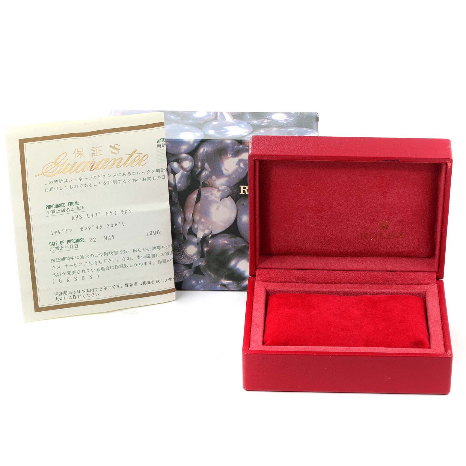 The image shows packaging for a Rolex Oyster Perpetual 67180 Women
s Stainless Steel White Dial 67180 Women
s Stainless Steel White Dial watch including a red velvet box, a guarantee card, and an outer cardboard box.