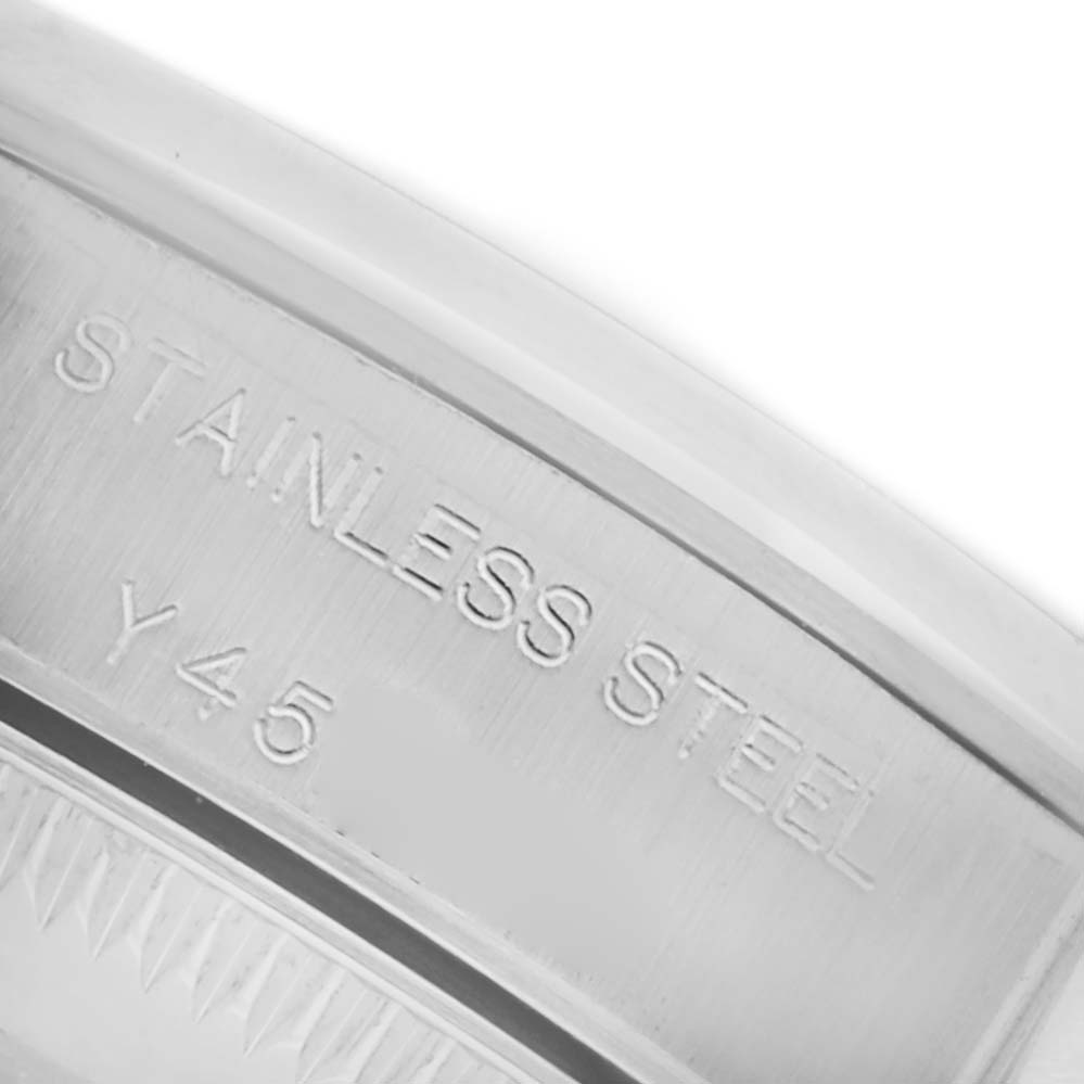 The image shows a close-up of the inner stainless steel bezel of the Rolex Oyster Perpetual 76080 Women's Stainless Steel Silver Dial 76080 Women's Stainless Steel Silver Dial watch, highlighting the engraving.