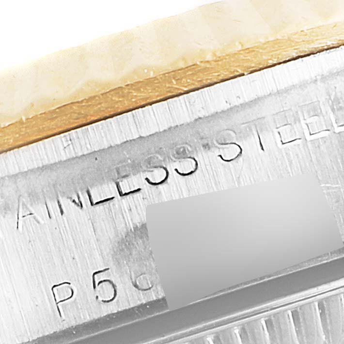 The image shows a close-up of the side of the case of a Rolex Oyster Perpetual 76193 Women
s Steel and Gold (two tone) Champagne Dial 76193 Women
s Steel and Gold (two tone) Champagne Dial watch, revealing the "STAINLESS STEEL" engraving.