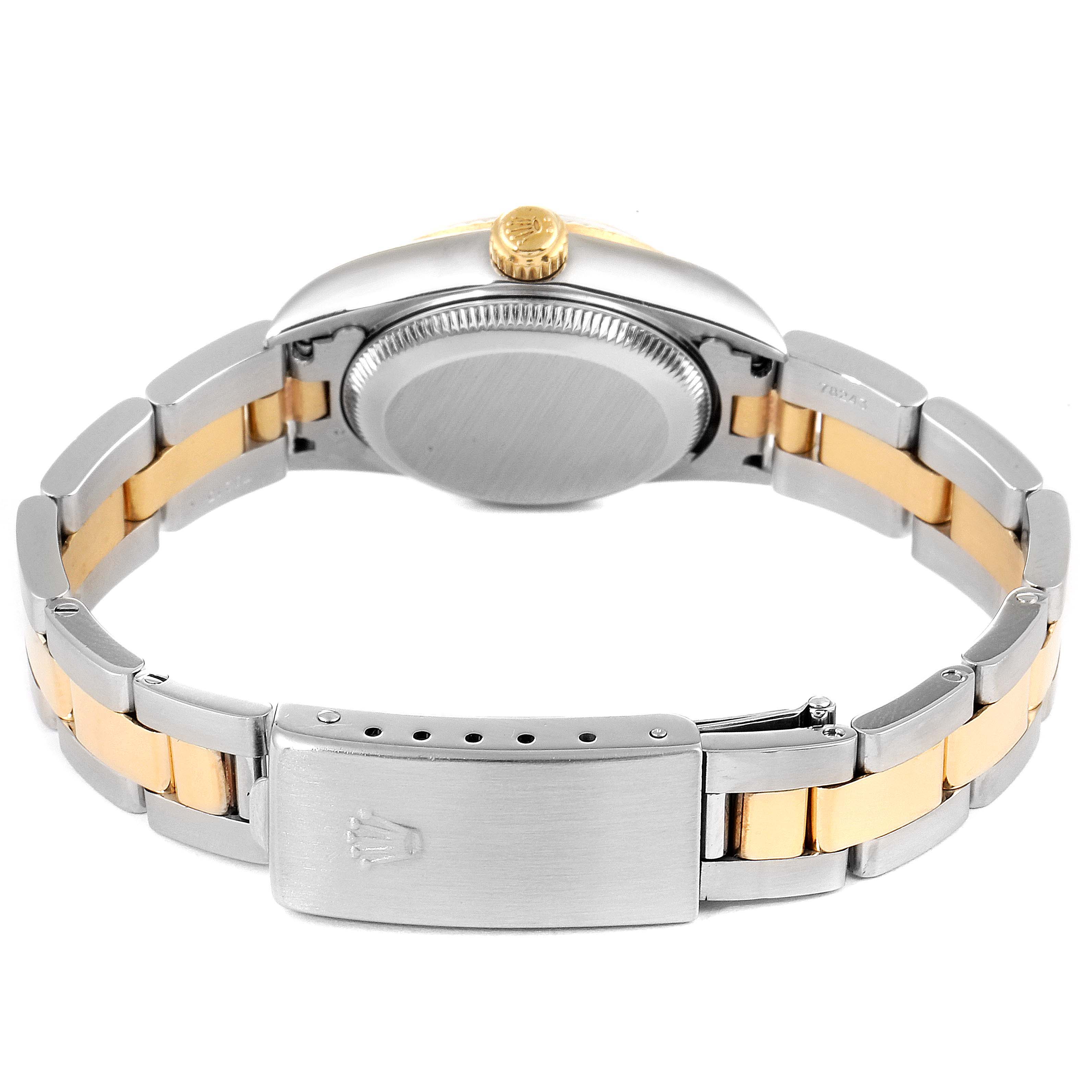 This image shows the back and bracelet of a Rolex Oyster Perpetual 76193 Women
s Steel and Gold (two tone) Champagne Dial 76193 Women
s Steel and Gold (two tone) Champagne Dial watch, highlighting its gold and silver links and clasp.
