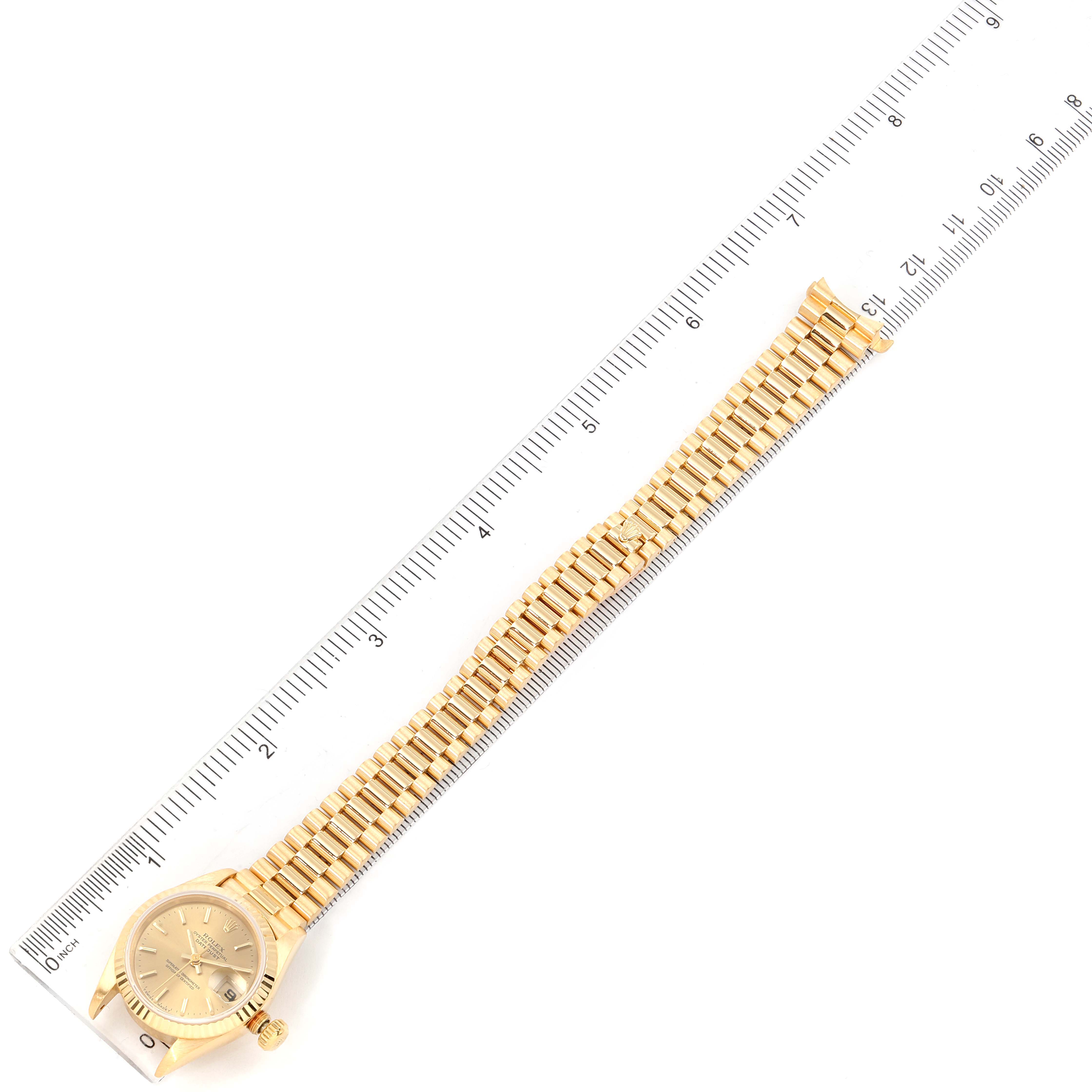 The image shows a Rolex President 69178 Women's Yellow Gold Champagne Dial 69178 Women's Yellow Gold Champagne Dial model watch, featuring its full face and bracelet, positioned alongside a ruler.