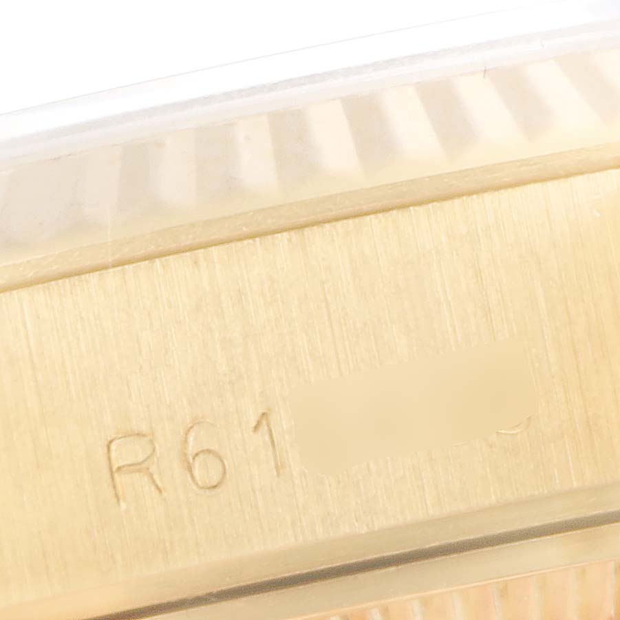 This close-up image shows the etched serial number on the case of a Rolex President 69178 Women
s Yellow Gold Black Dial 69178 Women
s Yellow Gold Black Dial model watch.