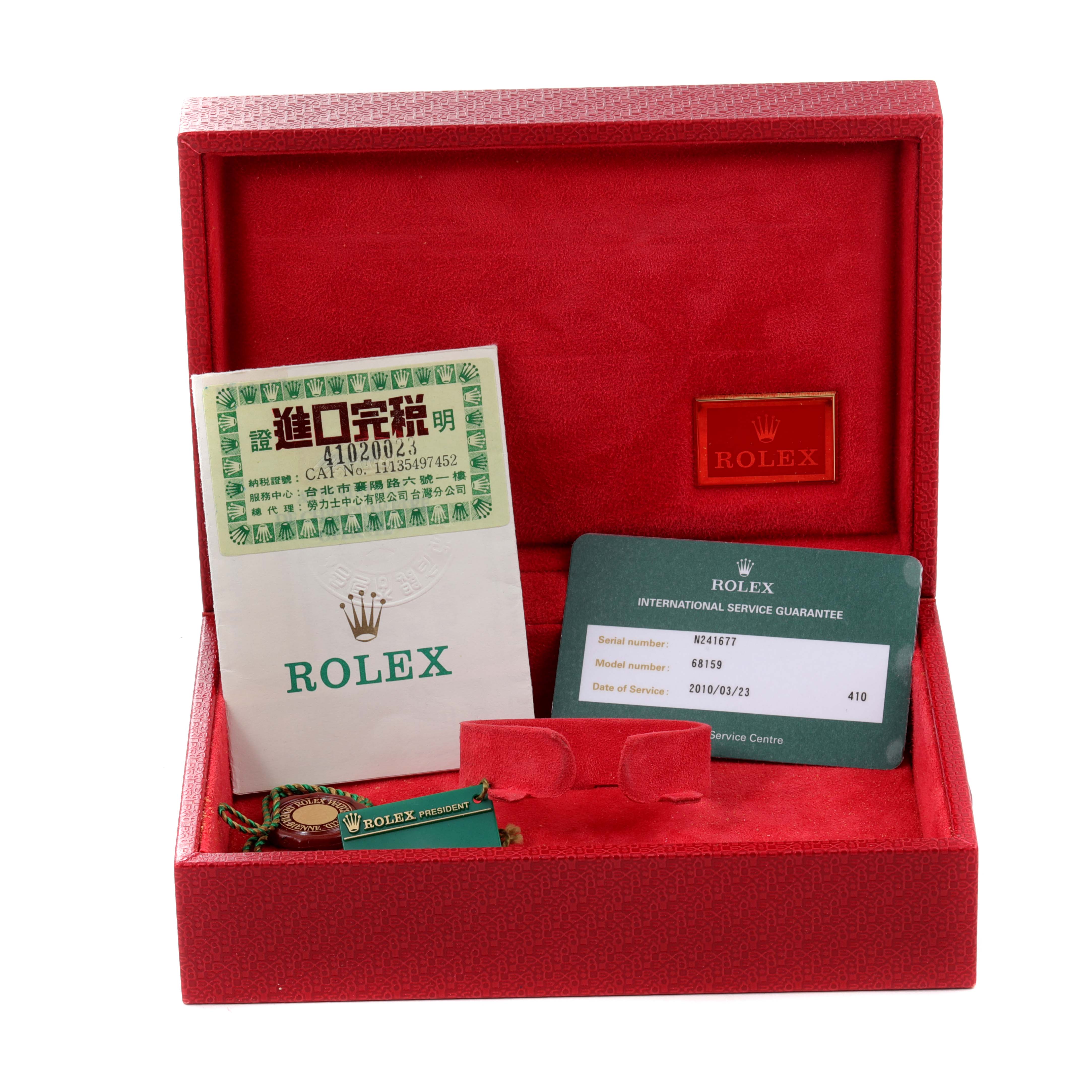 This image shows the accessories for the Rolex President 68159 Women's White Gold Grey Dial 68159 Women's White Gold Grey Dial model, including documentation and a tag, in an open red box.